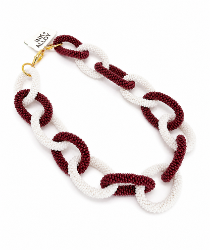 Ink + Alloy Gameday Chain Link necklace in burgundy and cream, flat lay with tag
