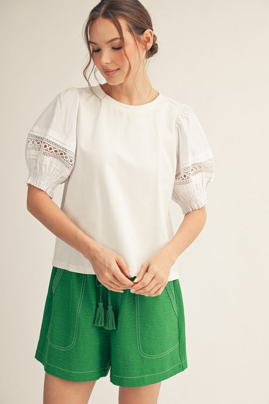 Jodifl Lace Accent Puff Sleeve Top in cream worn with green shorts, featuring lace-trimmed half sleeves