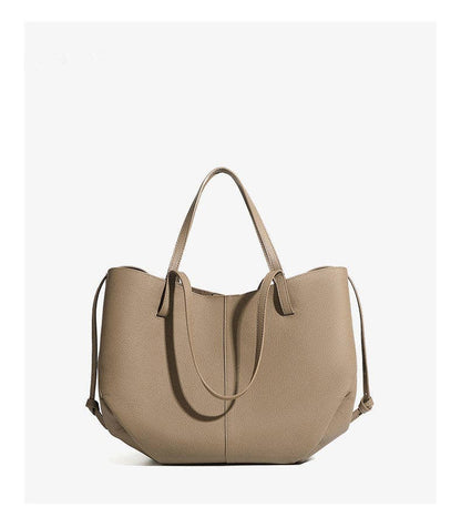 A large Parker & Hyde Brooklyn Tote in the color Oyster, featuring two handles, a minimalist design, and a slightly structured leather silhouette, displayed against a plain white background.