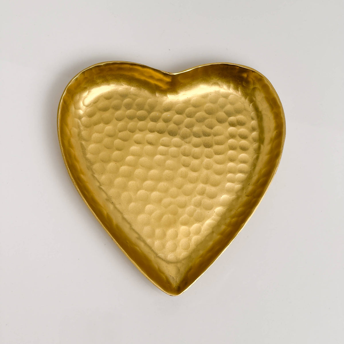 Gold hammered aluminum heart-shaped decorative tray, flat lay