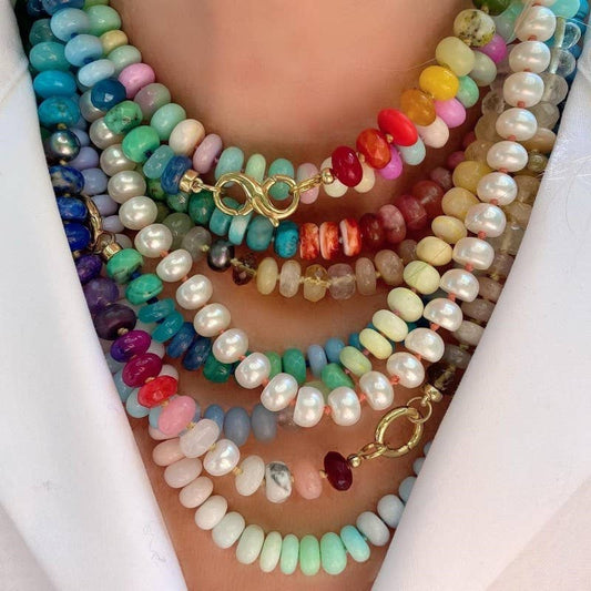 JOSSLYN by wall to wall multicolored semi-precious stone and glass beaded necklace worn, showing rainbow gradient from turquoise to red to cream