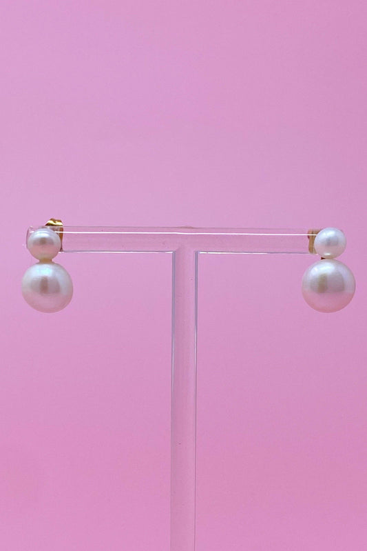 Classic Double Pearl Earrings on pink T-bar stand showing two-tier white pearl drops with gold posts