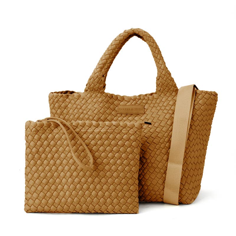 Two tan Parker & Hyde handbags in a matching basket-weave pattern: the Classic Woven Tote in Camel—a larger, durable tote with short handles and a long shoulder strap—and a coordinating smaller clutch equipped with a wristlet strap.