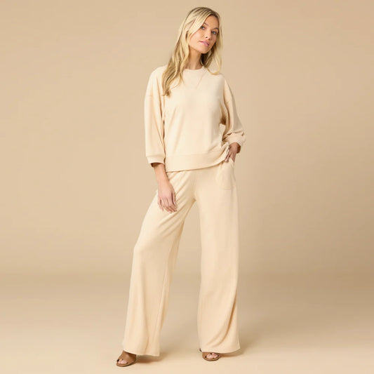 Woman wearing warm sand Softies terry cropped sleeve crew neck and wide leg pants, front view
