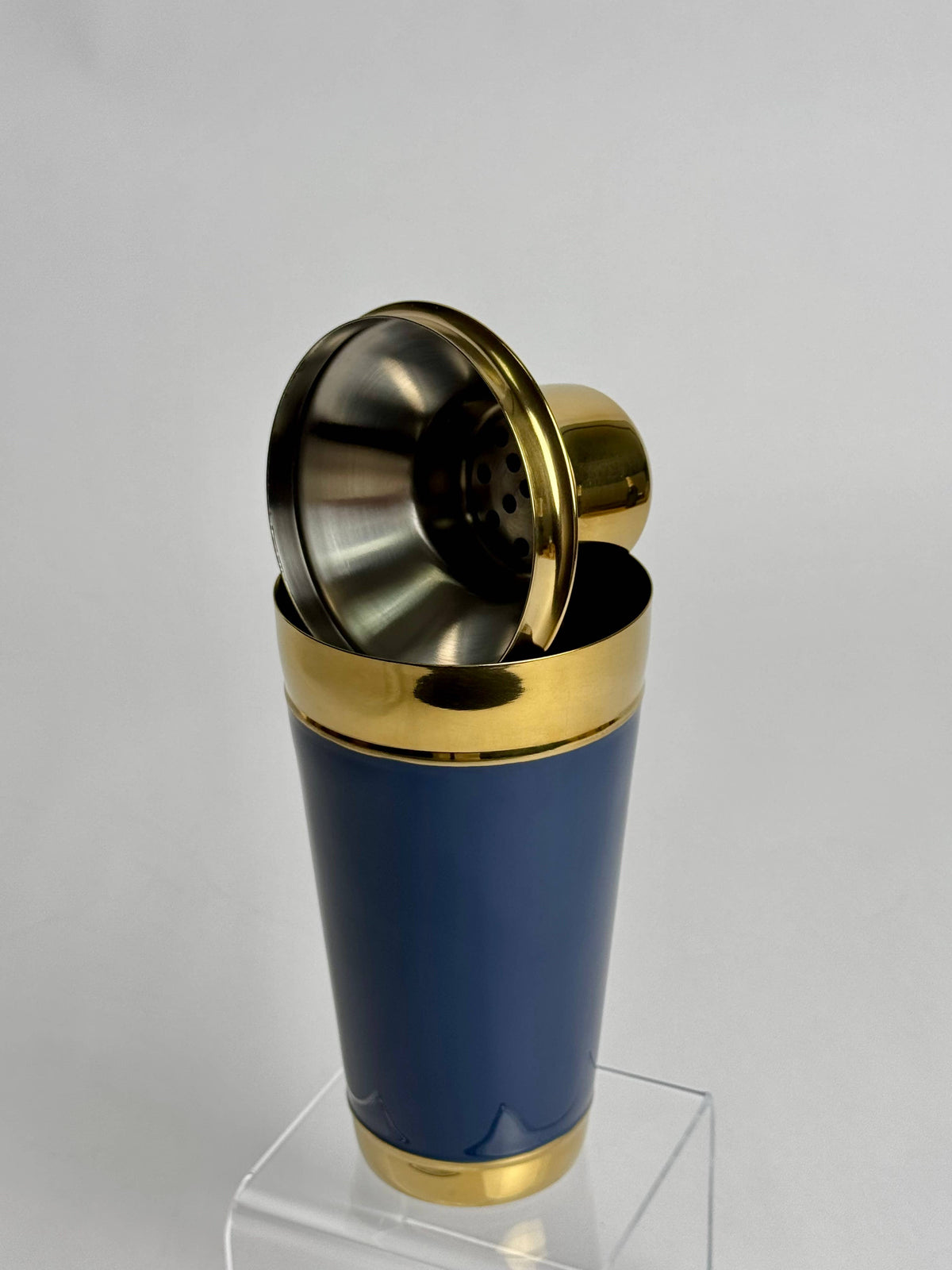 India Handicrafts Inc navy blue hand-painted cocktail shaker with brass trim and metal strainer top