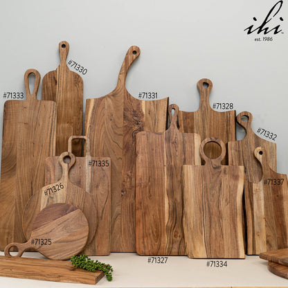 Flat lay display of India Handicrafts Inc acacia wood cutting boards, paddle boards, and round boards with handles