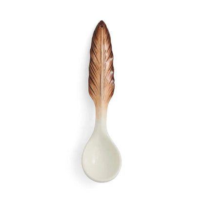 The Spode Woodland Pheasant Gravy Boat and Ladle by Spode features a ceramic ladle with a handle shaped and painted to resemble a brown pheasant feather, shown against a white background.