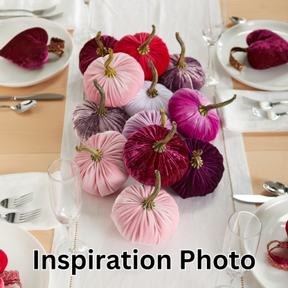 A collection of Your Heart’s Content - Pumpkin Small Velvet pumpkins in shades of pink, purple, and red rests on a white runner, surrounded by plates, cutlery, and glasses—perfect for an autumn table or as a Valentine’s mantel gift. The words “Inspiration Photo” appear at the bottom.