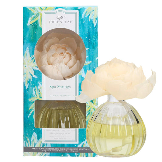 Greenleaf Gifts Spa Springs Flower Diffuser with cream peony flower and yellow-green liquid in ribbed glass bottle, turquoise packaging