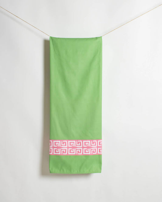 Lime green Royal Standard beach towel hung flat showing pink and white geometric trim band detail