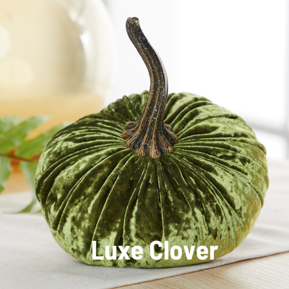 A large, green velvet pumpkin from Your Heart’s Content, featuring a dark stem, rests on a light surface—a perfect handcrafted decor piece for your fall mantel or Halloween table. The words “Your Heart’s Content” are displayed in bold white text at the bottom.
