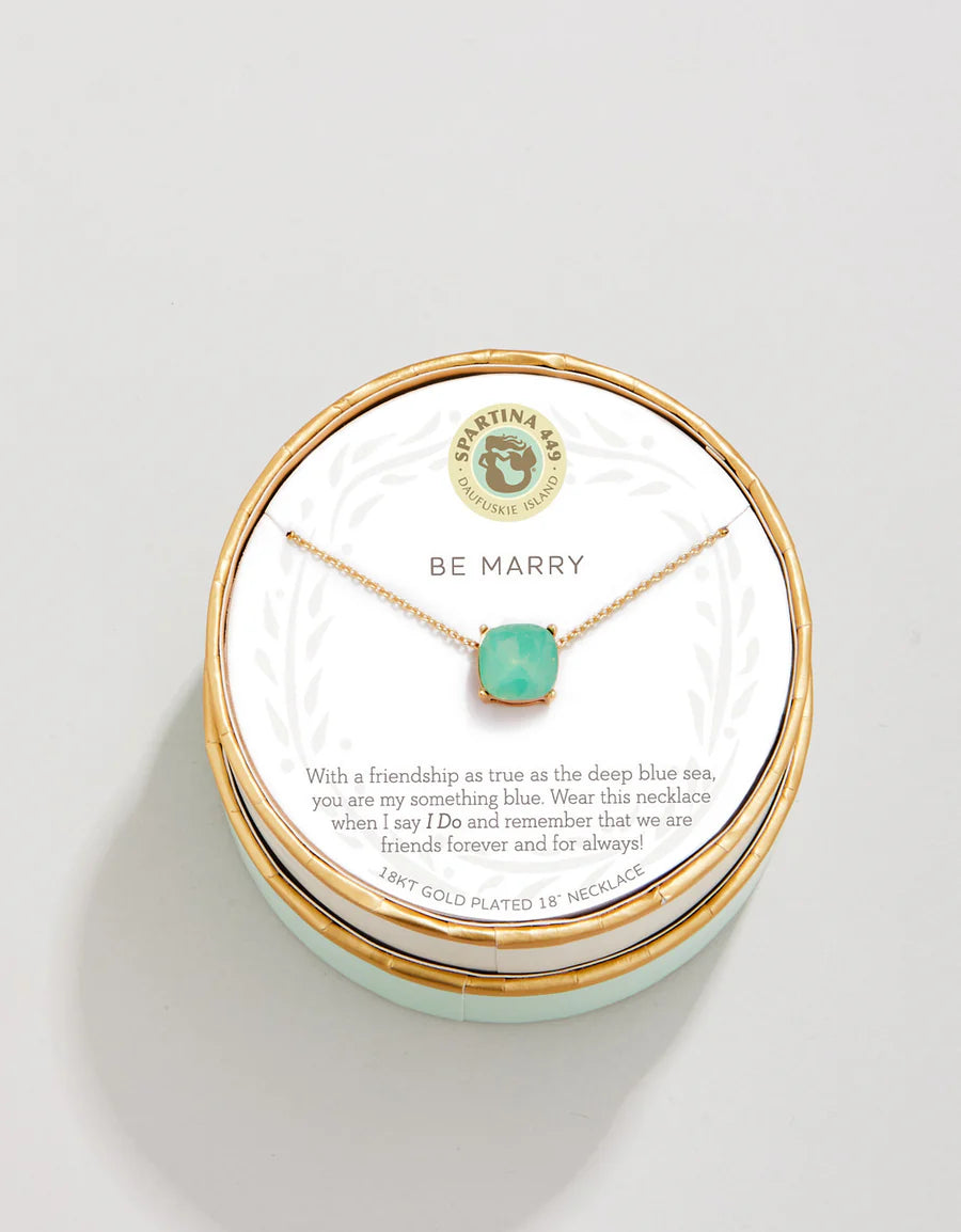 The Spartina Sea La Vie Be Marry Necklace by Spartina features a turquoise gemstone on a friendship necklace, elegantly displayed on a round card with the message “Be Marry” and a heartfelt friendship note. It comes beautifully packaged in a decorative box, making it perfect as something blue for a special occasion.