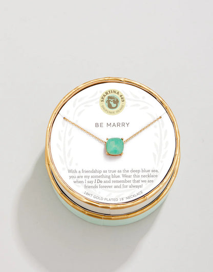 The Spartina Sea La Vie Be Marry Necklace by Spartina features a turquoise gemstone on a friendship necklace, elegantly displayed on a round card with the message “Be Marry” and a heartfelt friendship note. It comes beautifully packaged in a decorative box, making it perfect as something blue for a special occasion.