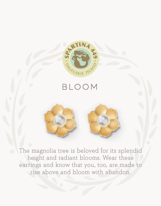 The Spartina Sea La Vie Bloom Stud Earrings by Spartina are showcased beneath the brand's logo, featuring gold flower-shaped studs with luminous pearl centers. Inspired by magnolia charms and the beauty of magnolia trees, these earrings symbolize personal growth and blooming with confidence—making them an uplifting and beautiful addition to any jewelry collection.