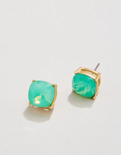 The Spartina Sea La Vie Sea Glass Stud Earrings by Spartina feature cushion-cut green gemstones set in gold prong settings and are displayed on a white background, making them a stylish alternative to something blue for your next special occasion.