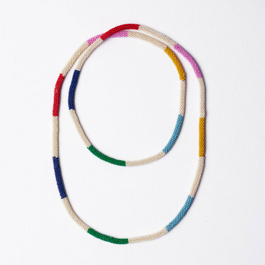 INK + ALLOY Allie Seed Bead Long Necklace in multicolor with cream base and color-blocked sections displayed flat