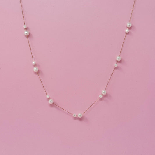 Ellison+Young Lovely Lady Dainty Pearl Necklace with rose gold chain and spaced white pearls on pink background