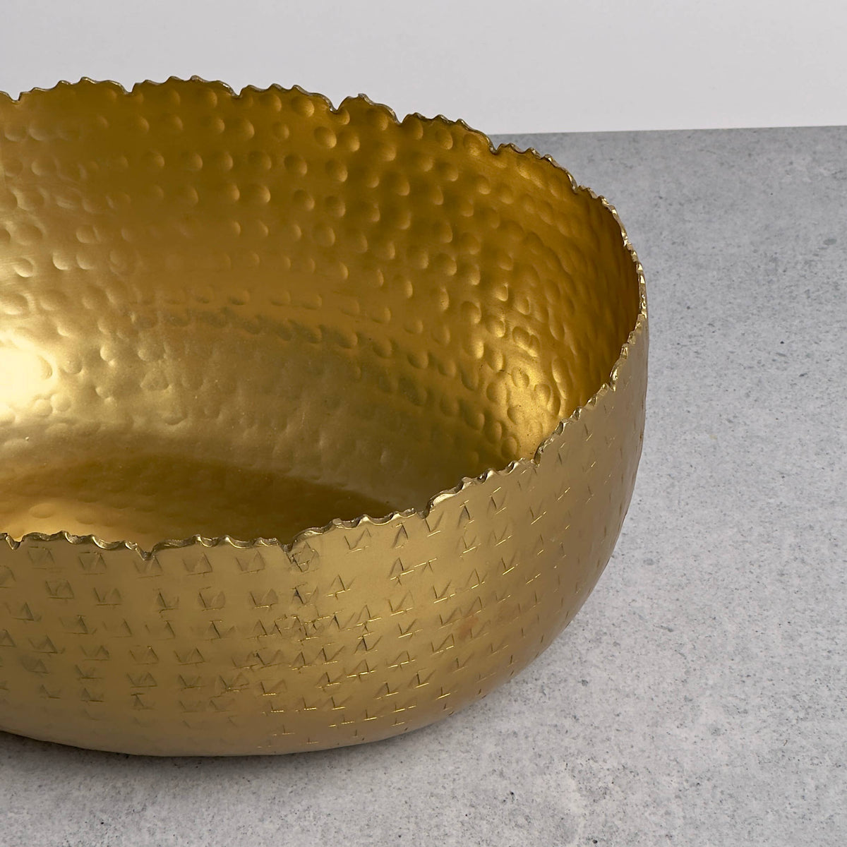 Gold hammered bowl angled side view showing interior texture and craftsmanship detail