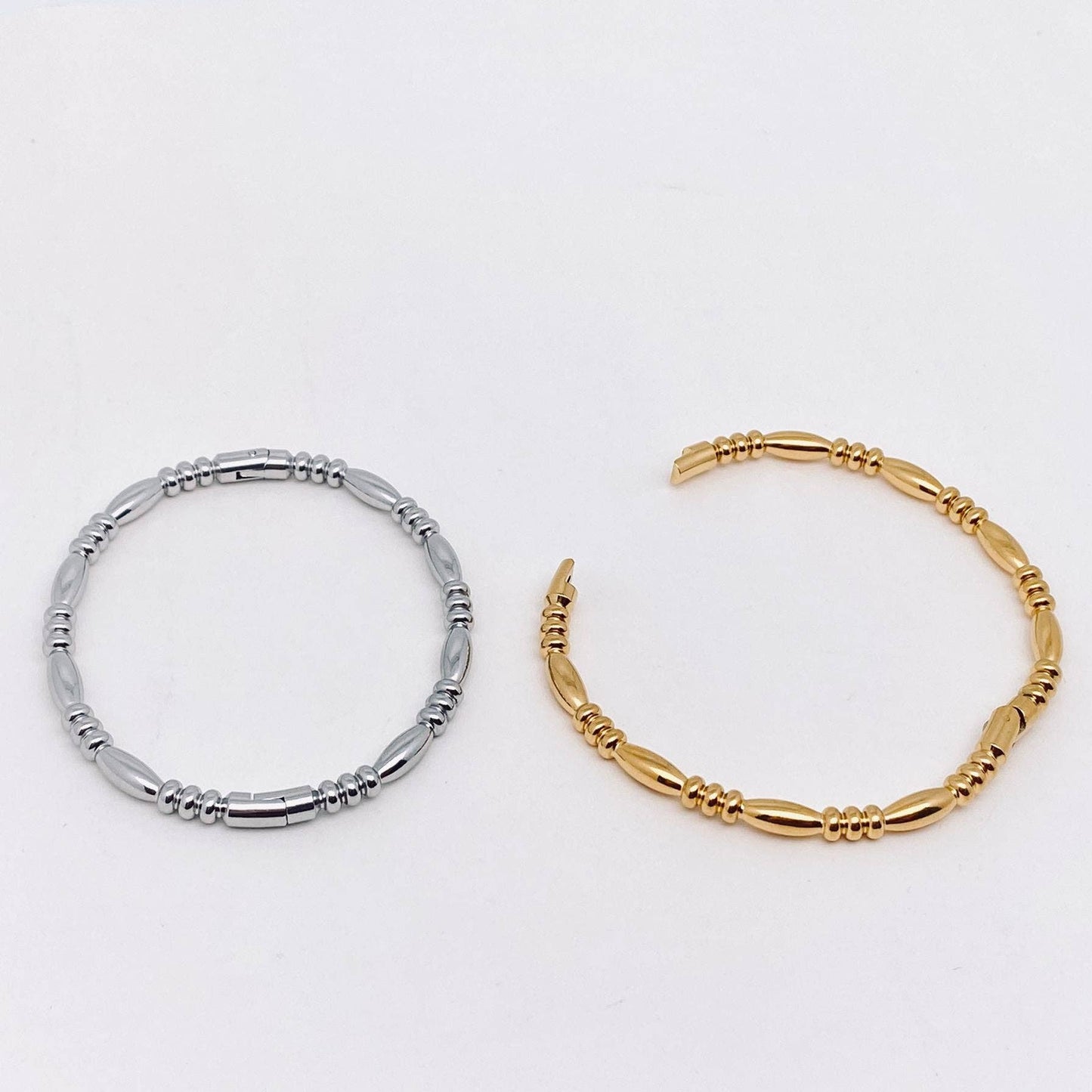 The Mio Queena Multi-style 18K Gold-plated Stainless Steel Bangle by Mio Queena is showcased against a plain white background, making it an ideal jewelry gift for any occasion.