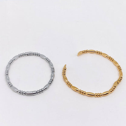 The Mio Queena Multi-style 18K Gold-plated Stainless Steel Bangle by Mio Queena is showcased against a plain white background, making it an ideal jewelry gift for any occasion.