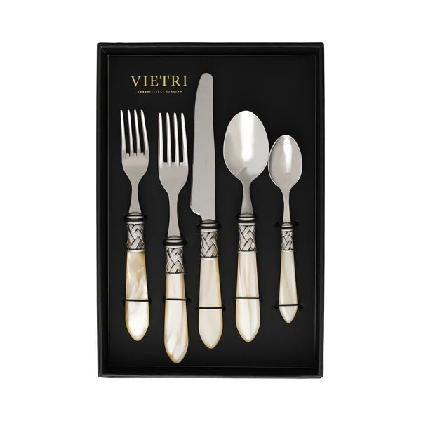 A boxed set of Vietri "Aladdin" Stainless Flatware in Ivory, featuring five pieces—including two forks, a knife, a spoon, and a teaspoon—with pearlized handles and ornate silver accents, all elegantly displayed on a black background.