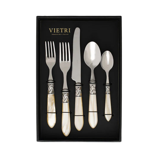A boxed set of Vietri "Aladdin" Stainless Flatware in Ivory, featuring five pieces—including two forks, a knife, a spoon, and a teaspoon—with pearlized handles and ornate silver accents, all elegantly displayed on a black background.