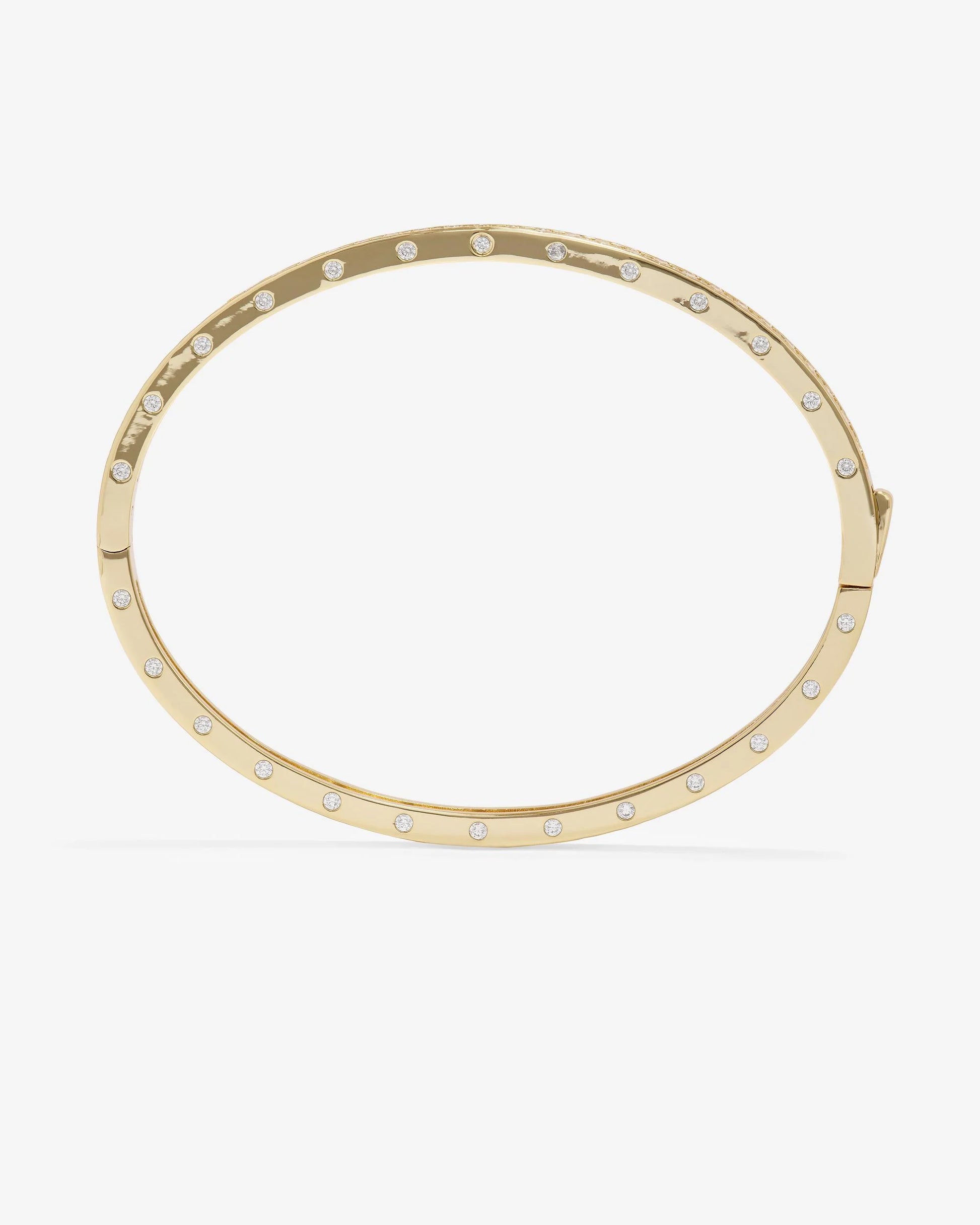 The Melinda Maria Ashley Pave Cuff Gold is an elegant 18k gold plated oval cuff bracelet by Melinda Maria, featuring evenly spaced small round pavé simulated diamonds along its outer edge for a touch of timeless sophistication to any ensemble.