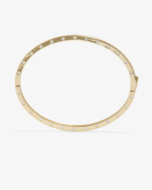 The Melinda Maria Ashley Pave Cuff Gold is an elegant 18k gold plated oval cuff bracelet by Melinda Maria, featuring evenly spaced small round pavé simulated diamonds along its outer edge for a touch of timeless sophistication to any ensemble.