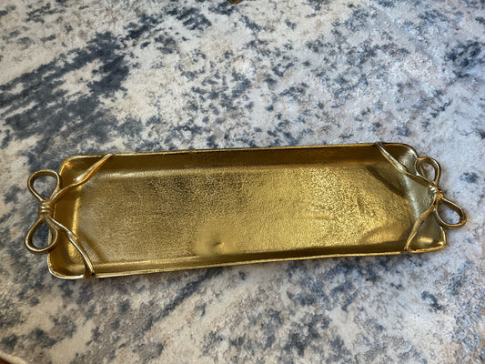 Two's Company large gold tray with brass bow handles on marble surface