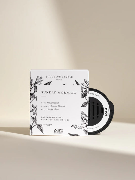 Brooklyn Candle Studio Sunday Morning car diffuser refill with white box and black Pura smart scent device