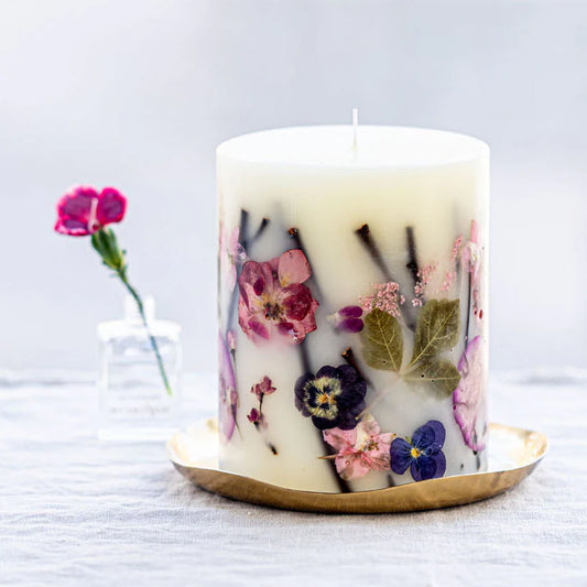 Rosy Rings Accent Botanical Candle with pressed pink and purple flowers on brass plate holder