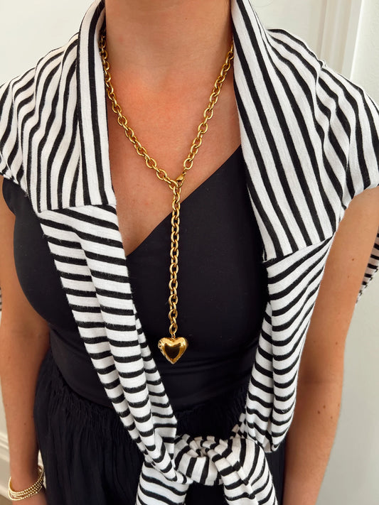 CHANSUTTPEARLS XL Heart Necklace in gold with chain worn on striped black and white shirt