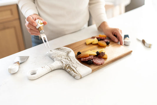 Lynn & Liana Medium Acacia Cheese Board with white resin handle being used to serve charcuterie and cheese