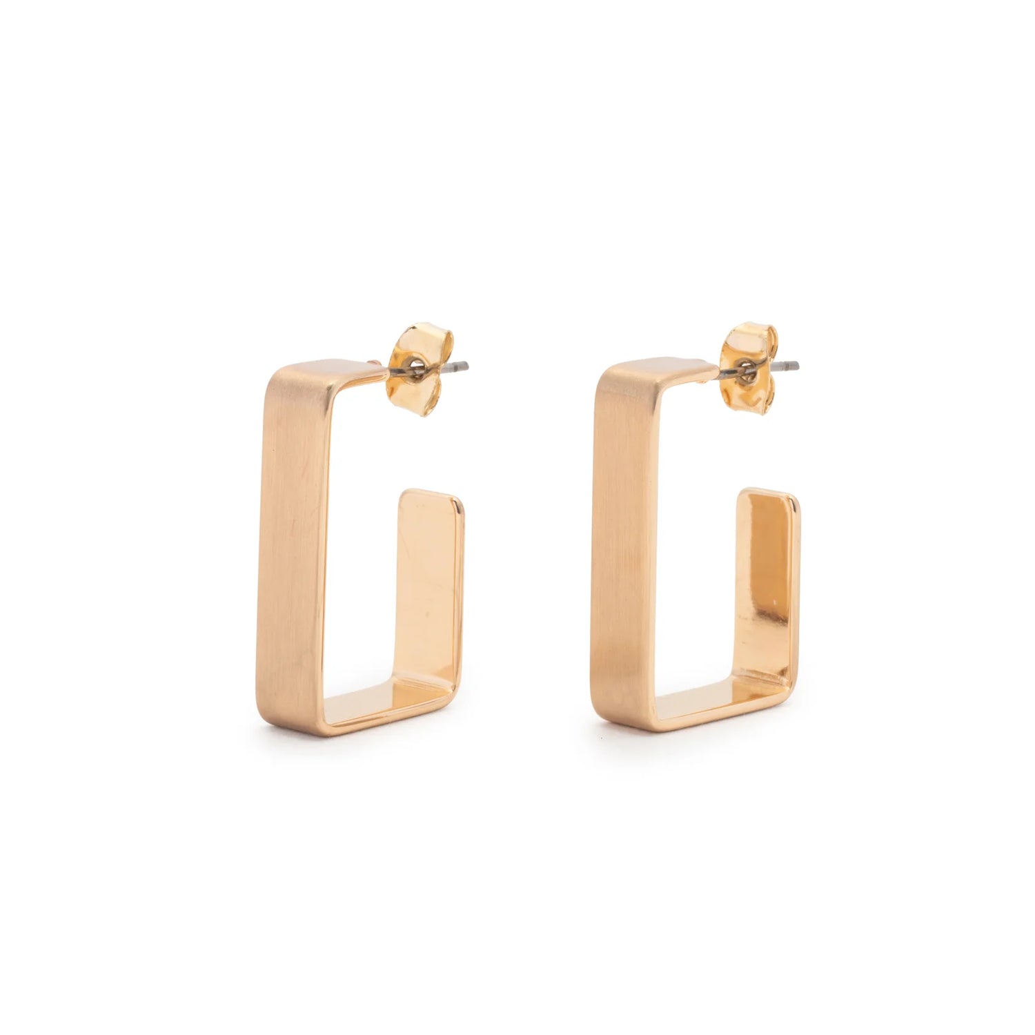 The Leslie Curtis Emmie Earrings by Leslie Curtis are a pair of brushed gold rectangular hoop earrings with straight edges, featuring a rectangle post and secure stud backings. Viewed at an angle, they showcase a geometric, modern design. Each hoop measures approximately 1 inch in length.