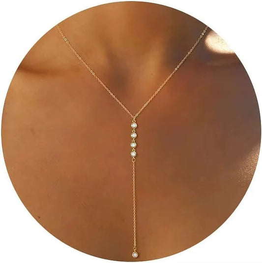 Coastal Grit Elara Lariat Necklace in gold with white pearl stations draped down the center