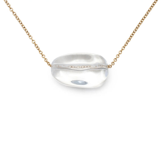 Introducing the Leslie Curtis Sabrina Necklace by Leslie Curtis—a delicate, tarnish-resistant 14-inch gold chain showcasing a single clear oval glass bead with a silver line through its center. This necklace embodies timeless elegance and subtle sophistication, making it perfect for any occasion.