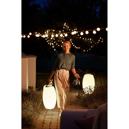 Kooduu Synergy 50 white LED lamps glowing at night in outdoor garden setting
