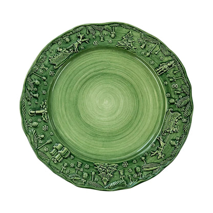 The Vietri Fiabe Di Natale Green Dinner Plate by Vietri is a handpainted ceramic plate with a raised rim, adorned with festive holiday motifs such as reindeer, trees, snowflakes, and pinecones—all rendered in the same elegant green hue as the plate itself. Combining seasonal charm with enduring quality, this holiday plate brings both durability and sophistication to your table.