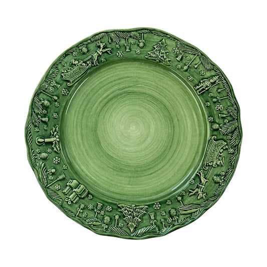 The Vietri Fiabe Di Natale Green Dinner Plate by Vietri is a handpainted ceramic plate with a raised rim, adorned with festive holiday motifs such as reindeer, trees, snowflakes, and pinecones—all rendered in the same elegant green hue as the plate itself. Combining seasonal charm with enduring quality, this holiday plate brings both durability and sophistication to your table.
