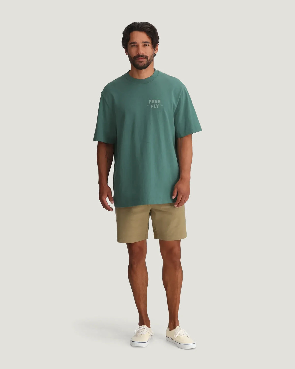 Man wearing Free Fly Gear & Goods Relaxed Tee in sage green with khaki shorts, full outfit