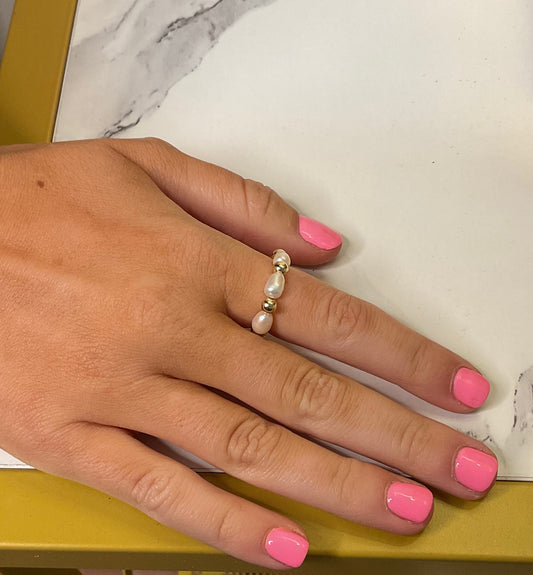 Coastal Grit Savannah Ring worn on finger, white pearls with silver accents, styled with pink nail polish