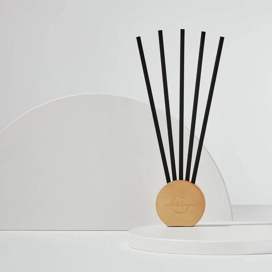 Glasshouse Scent Scene metal vessel in champagne gold with five black reed diffuser sticks