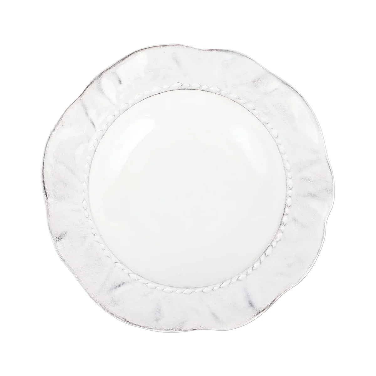 A round, white ceramic Vietri “Giorno - Ash” Pasta Bowl with a wavy, textured rim and a subtle decorative pattern near the edge is shown on a white background.