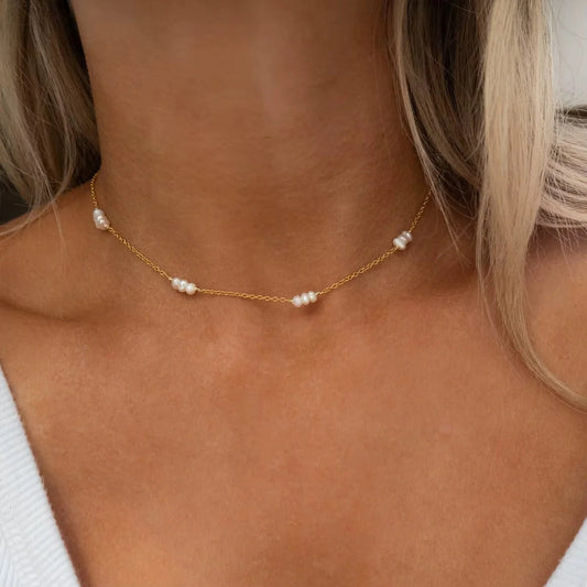 Coastal Grit Amelie Pearl Necklace with spaced white pearl clusters on gold chain, worn