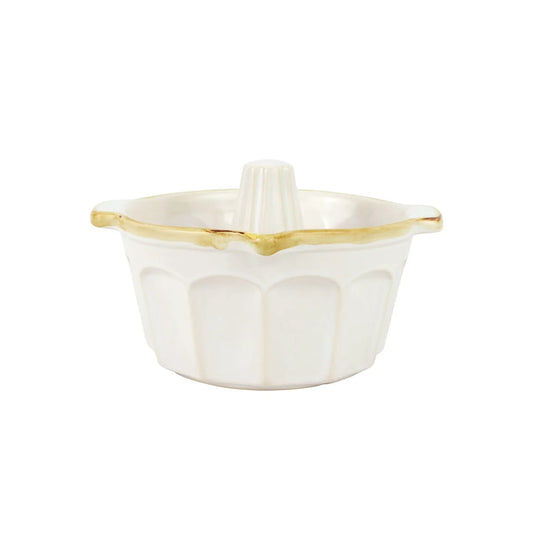 The Vietri Italian Bakers White Bundt Pan by Vietri is a white ceramic pan with a fluted design and a gold rim along the top edge, crafted from durable Italian stoneware, displayed on a plain white background.