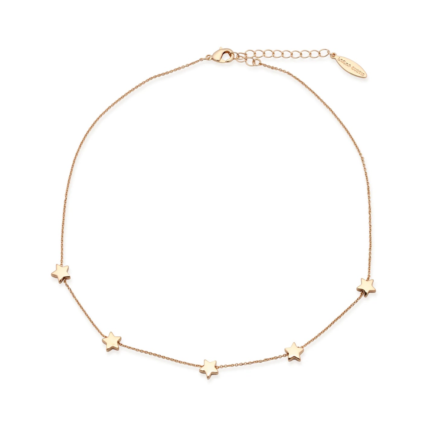 The Leslie Curtis Jett Necklace by Leslie Curtis is a delicate gold necklace featuring five small, tarnish-resistant star charms evenly spaced along the chain, an adjustable clasp, and a small engraved tag near the closure.