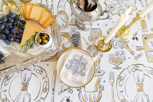 Hester & Cook Chandelier Cocktail Napkins in cream with black illustrated champagne glasses and bar illustrations