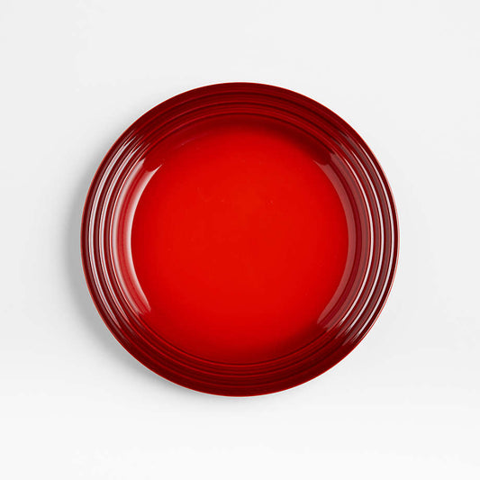 Le Creuset red salad plate viewed from above showing glossy finish and rim detailing