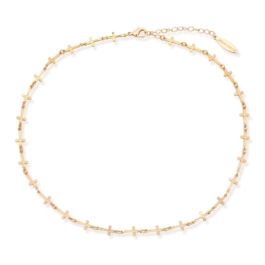 The Leslie Curtis McKay Necklace by Leslie Curtis is a delicate and minimalist layering piece featuring small, evenly spaced cross-shaped charms along a 16-inch chain. It includes an adjustable clasp and a branded tag, making it perfect for creating a subtle, elegant cross layering necklace look.