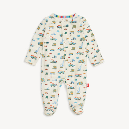 Magnetic Me Dumps Like A Truck Footie in cream with colorful truck and construction vehicle print throughout